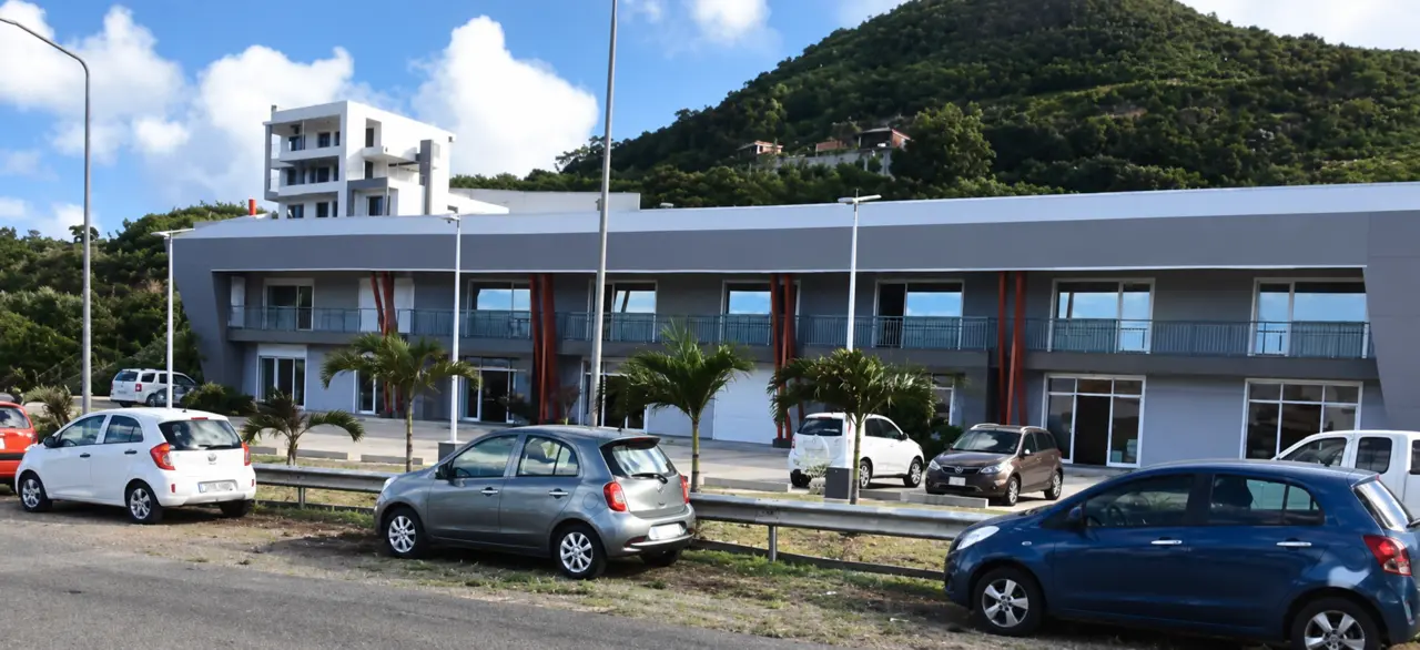 Street-facing and courtyard views of commercial buildings with grey and white finishes.