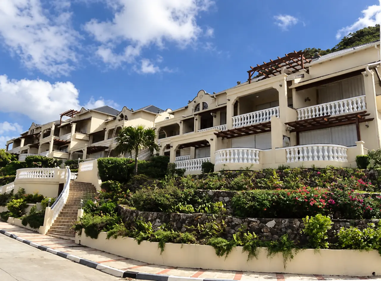 Pale residential facades, open balconies and landscaped terraces.