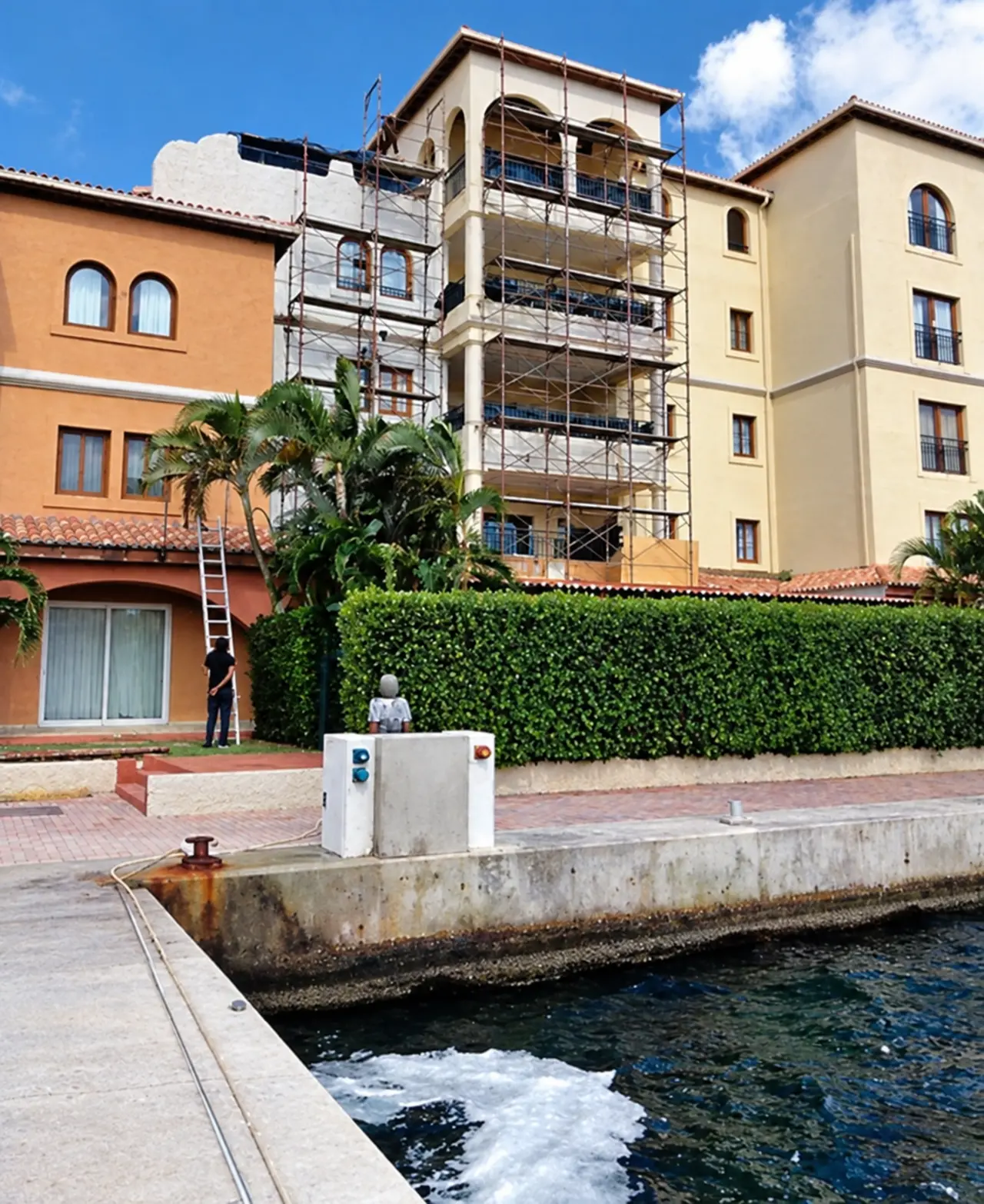 A waterfront elevation with scaffolding in place.