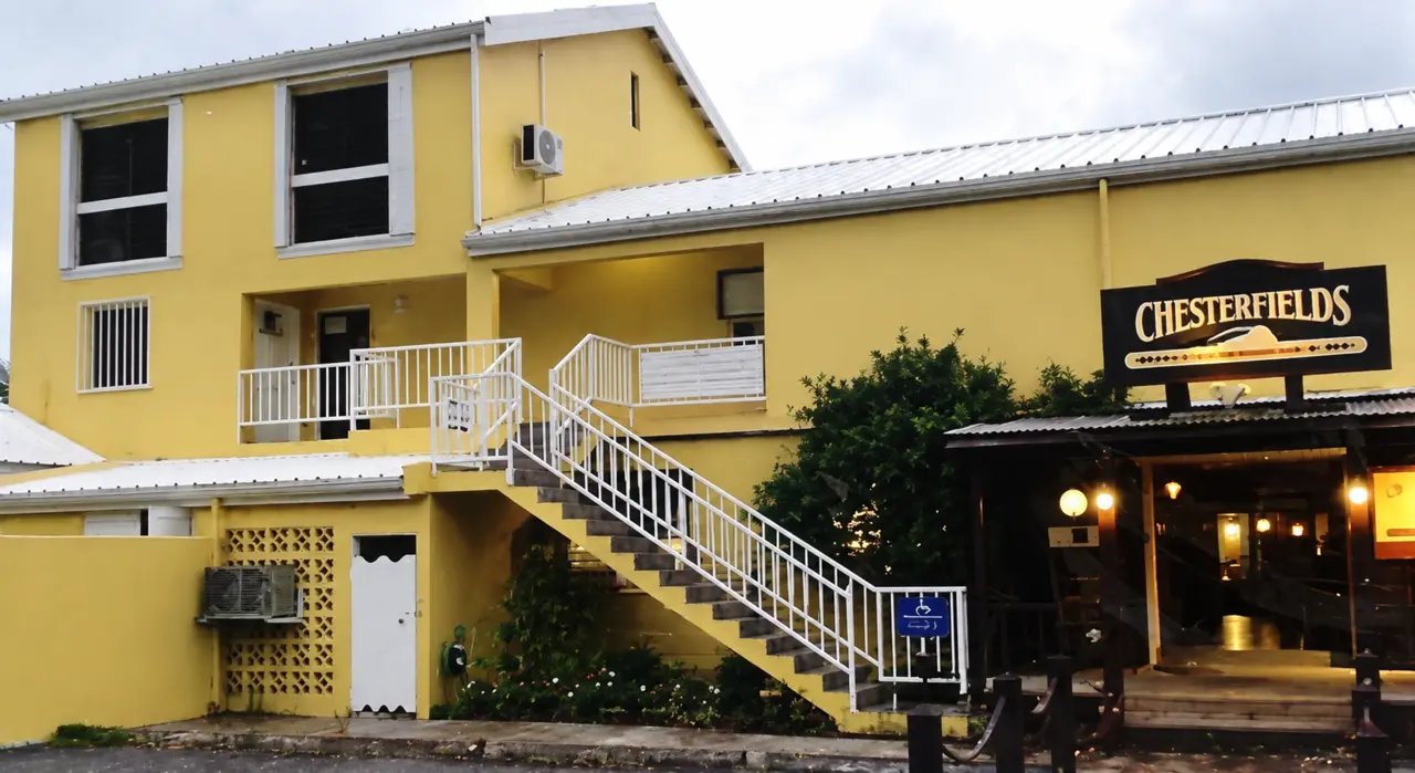 Yellow and cream exterior views, entrance details and outdoor walkways.